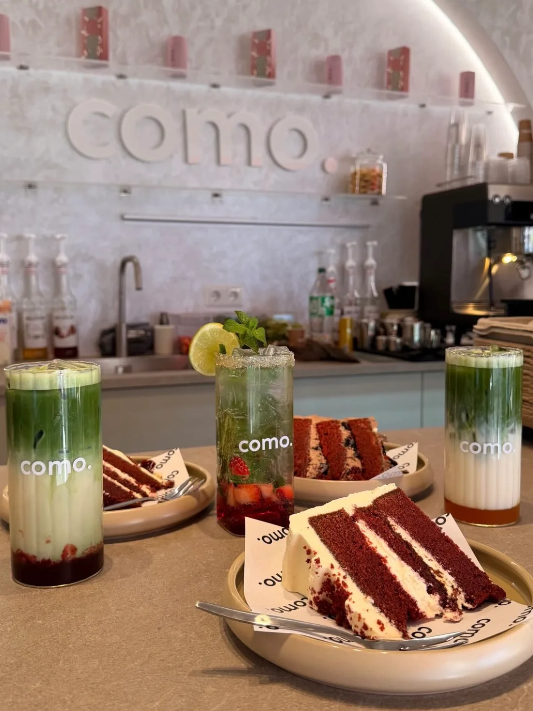 Een gedekte tafel bij COMO met matcha, een mocktail en meerdere punten taart